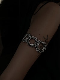 a woman's arm with a silver bracelet on it